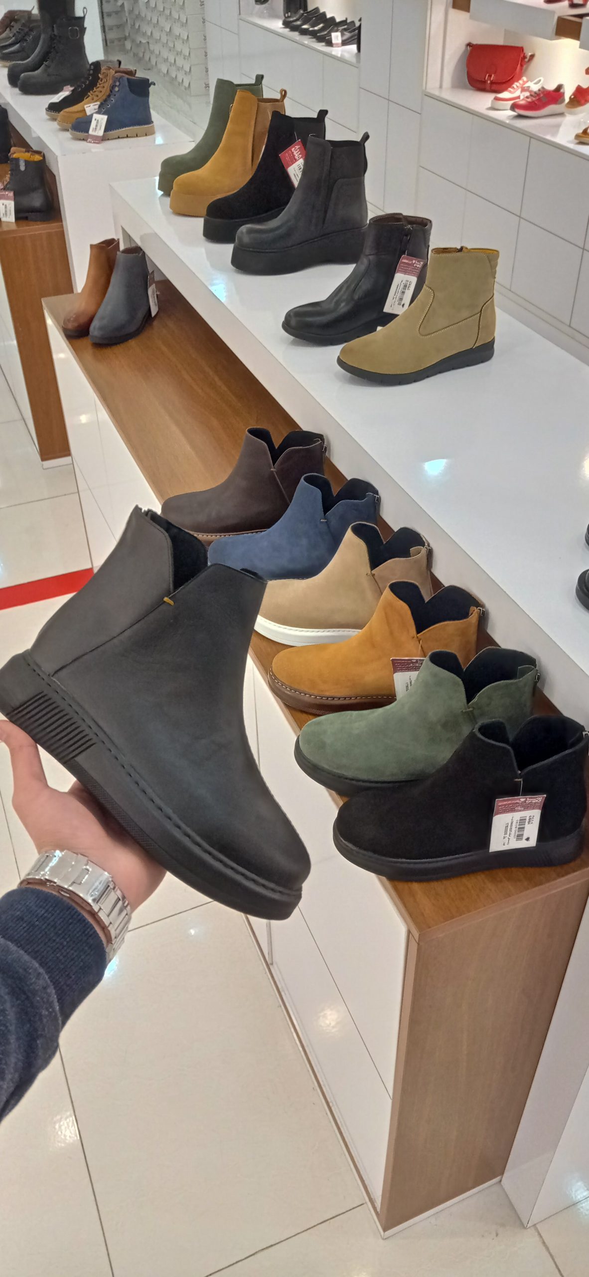 leather boots in hand